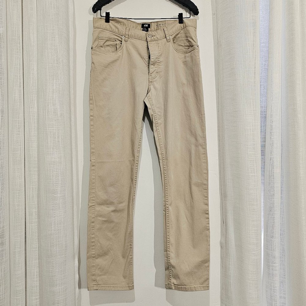 5-pocket Chino / Khaki pant with a regular waist, button fly, and slim legs.